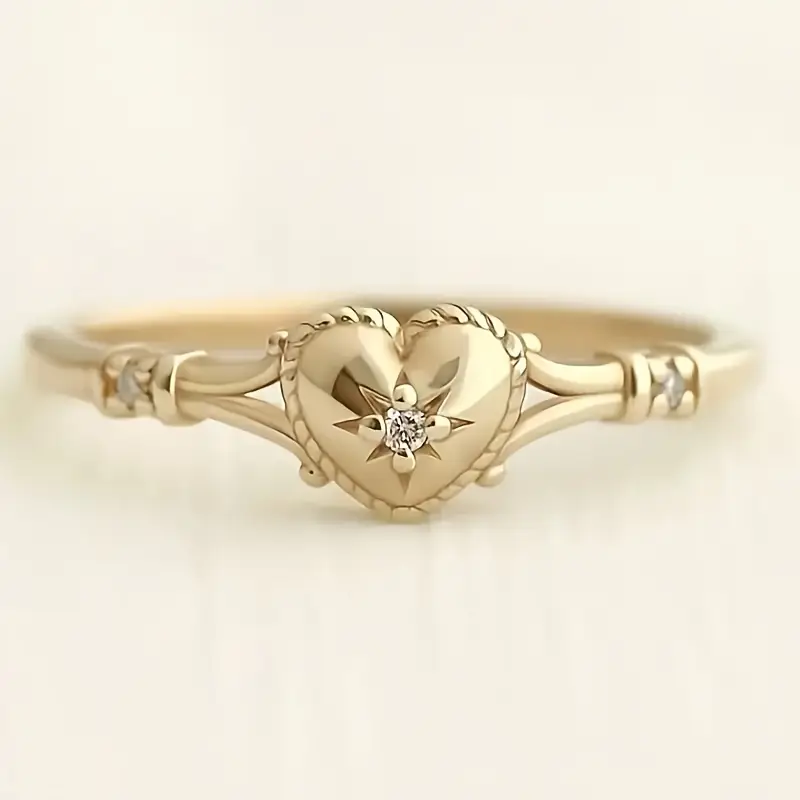 Eleganter goldener Herz und Sternring